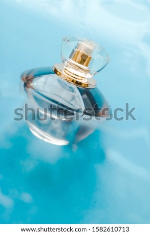 Perfumery, cosmetics and branding concept - Perfume bottle under blue water, fresh sea coastal scent as glamour fragrance and eau de parfum product as holiday gift, luxury beauty spa brand present