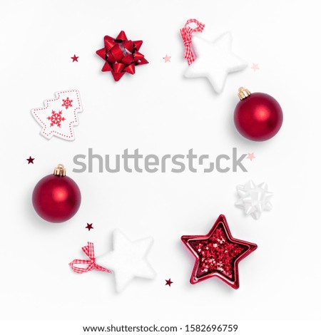 New Year and Christmas composition. Wreath from red balls, white stars, chrismas tree on white paper background. Top view, flat lay, copy space, for instagram Royalty-Free Stock Photo #1582696759