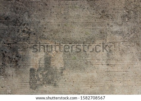 Concrete wall closeup photo. Speckled cement surface
