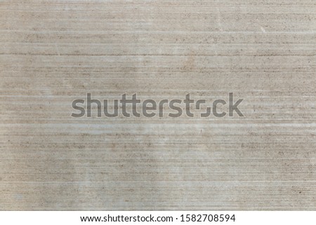 Brown concrete floor texture with small dash pattern. Close-up of speckled grunge background