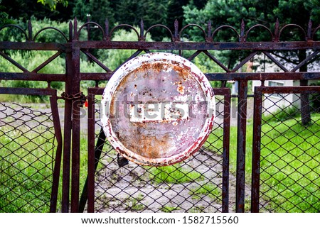 close-up old stop sign on the rusty gate