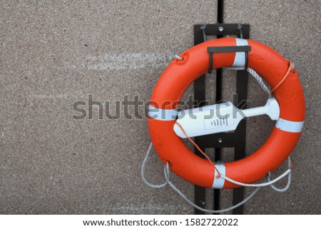 Lifebuoy ring on a cement wall