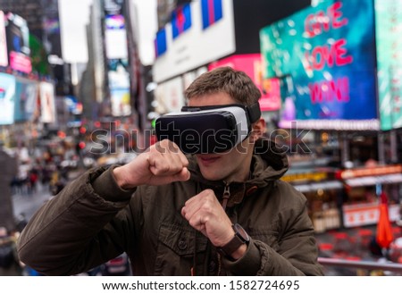 Man using virtual reality in Time Square, New York