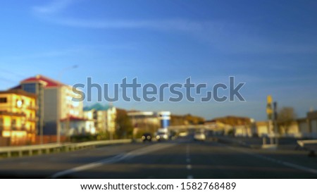 blurred background. the view from the front Windows of a moving vehicle on city streets.