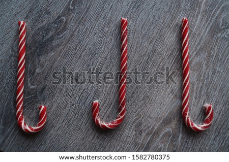 Photo of christmas red candies on a wooden background.