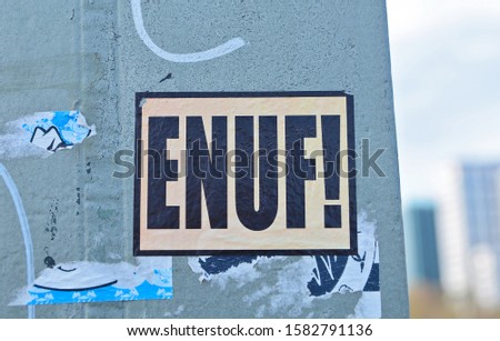 Sticker art with the slogan "ENUF!" - protest