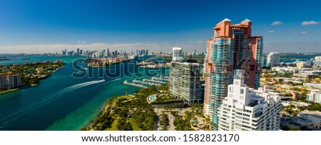 Aerial panorama Miami Beach highrise condominium buildings inlet and port on a beautiful day