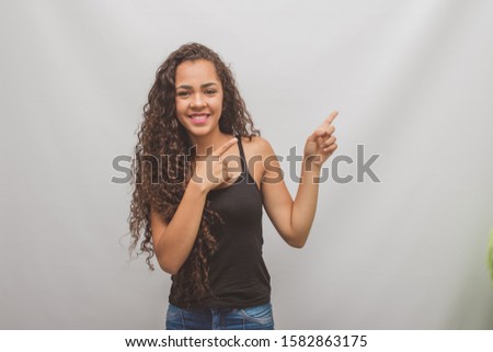 Happy Young Woman Isolated Presenting On gray Background with copy space
