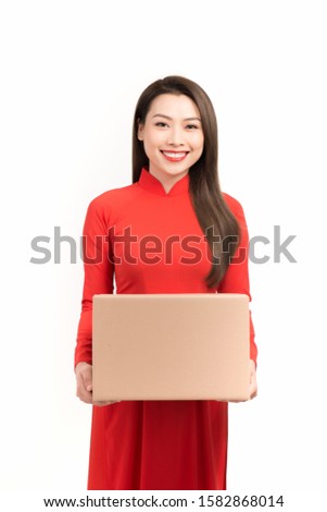 Asian woman with ao dai and hold big gift box