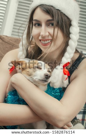 young woman embraced with jack russell terrier closeup portrait