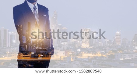Double exposure of business man on city night background.technology for business concept.