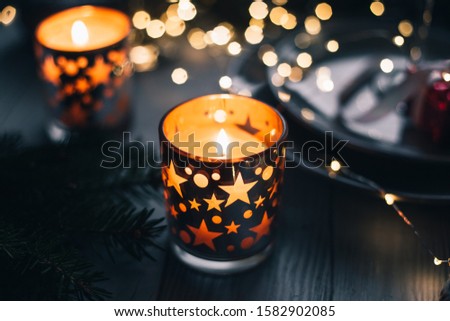 Christmas or New year composition with burning candles in the dark.
