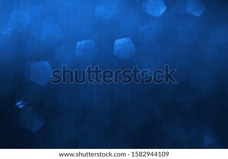 glitter classic blue lights background. de-focused. color of the year 2020