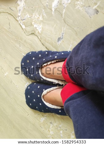 Cozy, warm and comfortable slippers on the feet. woman feet in cute slippers,