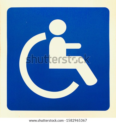 Wheel chair disabled/handicapped parking permit sign board in blue color