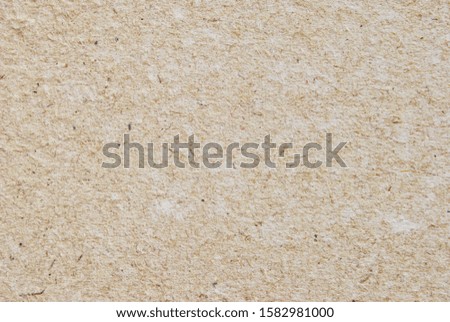 A sheet of rough recycled craft paper texture as background