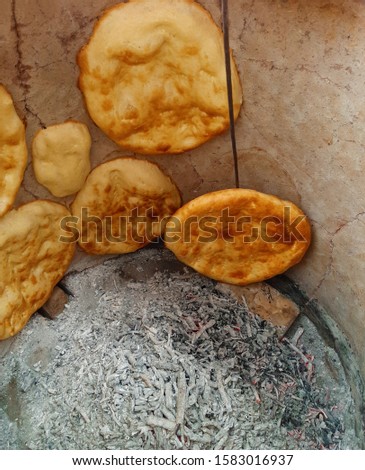 Azerbaijan and Caucasian Traditional bread is Tandoori bread. Tandir bread. Fresh village bread. Royalty-Free Stock Photo #1583016937