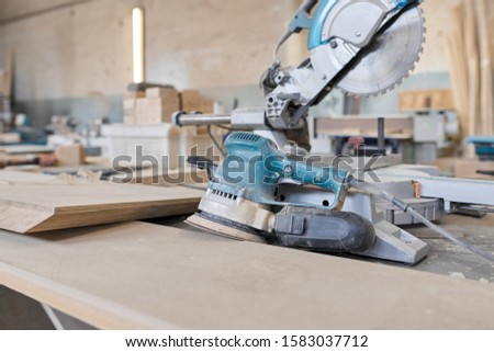 Background carpentry woodworking woodshop, machines and tools, wooden boards, furniture details Royalty-Free Stock Photo #1583037712