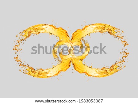 Decorative infinity sign from splashing light beer waves on a light grey background with copy space.