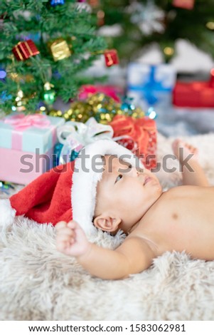 Cute Little Baby with Christmas box gift On A Christmas Day.