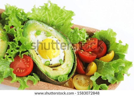 Avocado with egg and vegetables.