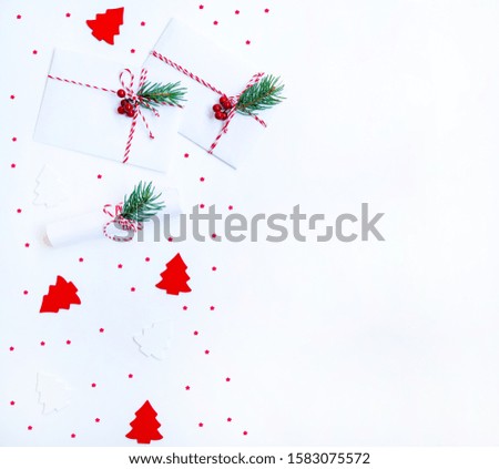 Christmas composition. Christmas gift, decoration, fir branches on light background. Flat lay, top view, copy space