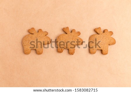 background with ginger biscuits on craft paper, three deers