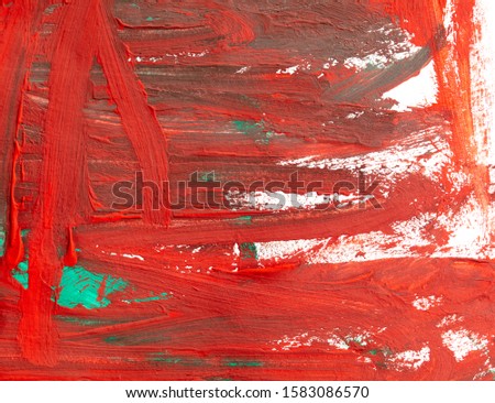 Red and green paints on white paper as an abstract background.