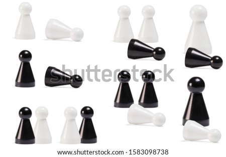 Black and white game pieces. Perfect for representing racism or bullying. Creative concept for antiracism or antibullying campaign.