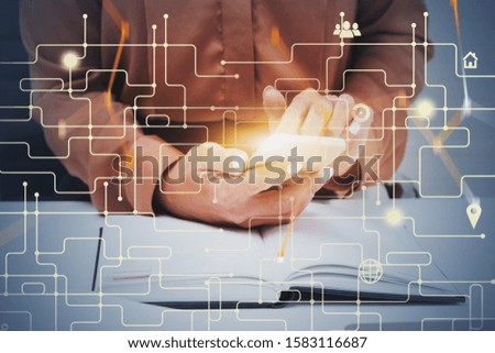 Businesswoman using smartphone in office with double exposure of blurry hi tech interface. Concept of fintech and modern technology. Toned image