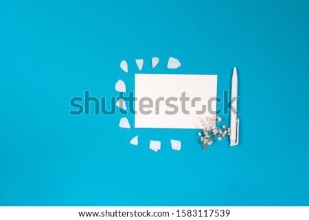 Letter and small accessories on blue background. Blank writing space. Top view
