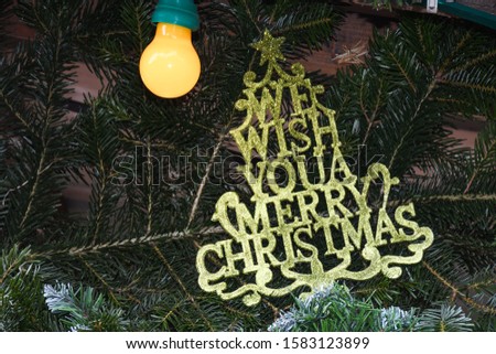 We wish you a merry Christmas text message in fir branch tree. Festive seasonal greeting card