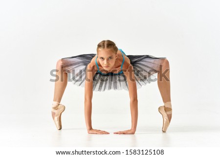 Woman ballerina doing elasticity exercise
