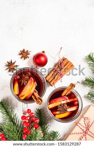 Mulled wine with christmas decorations. Christmas hot drink on white stone table with copy space top view.