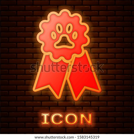 Glowing neon Pet award symbol icon isolated on brick wall background. Badge with dog or cat paw print and ribbons. Medal for animal.  