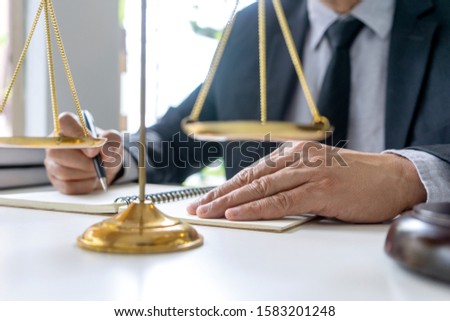 In the office of Judge or lawyer, there are balance and gavel on the table. Law firm Concept.