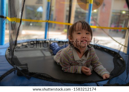 Little girl playing on the jumping board