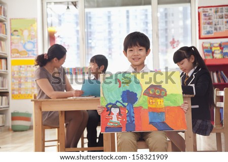 Portrait of one student holding painting