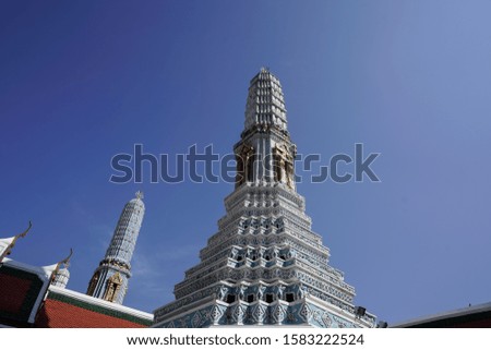 the beautiful white pagoda with the blue sky in bangkok . thailand