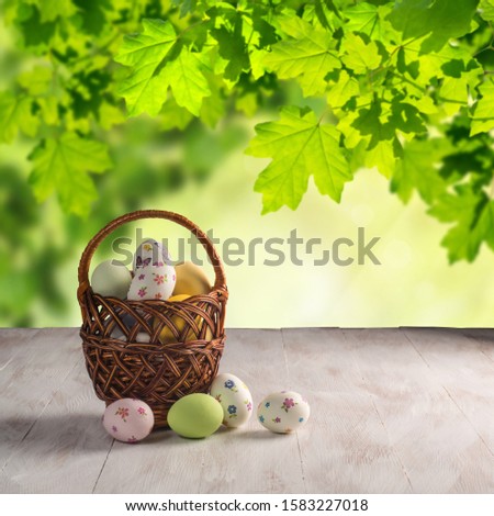 Happy easter painted eggs on wooden colorful table, holiday background for your decoration. Copy space