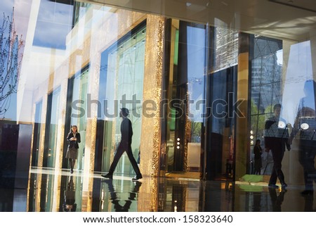 Business people walking through the lobby of an office 