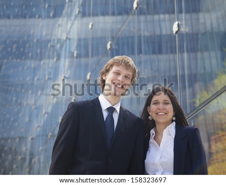 Portrait of two smiling young business people outdoors in Beijing
