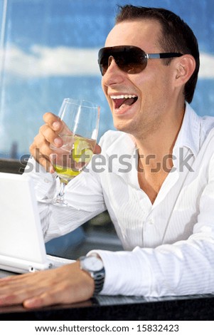 picture of handsome man with glass of water and laptop