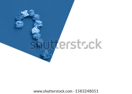 Question mark lined with crumpled paper on blue background top view copy space Asking, Decisions. FAQ concept. Concept ideas. Flat lay. Color of the year 2020. Trend color