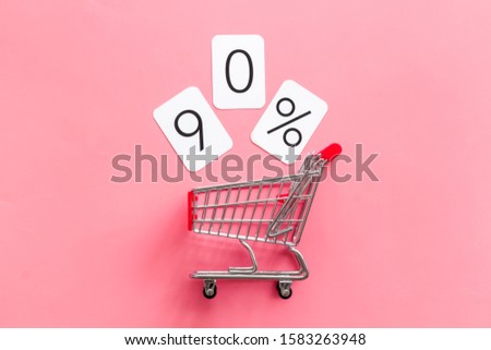90% off discount - sale concept with shopping trolley cart - on pink background top-down copy space