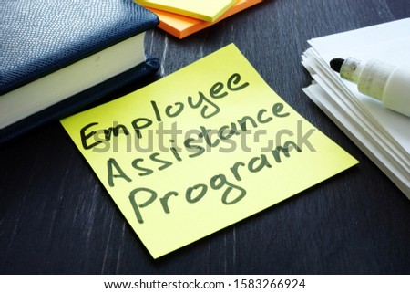 Employee assistance program EAP sign and pile of papers. Royalty-Free Stock Photo #1583266924