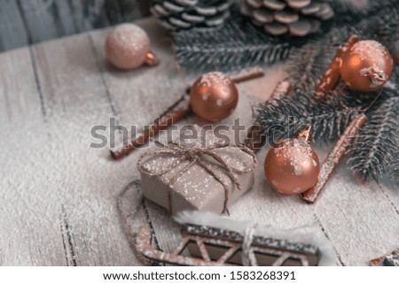 Christmas background with toys, balls, cinnamon, sprigs of Christmas tree and sled. Place for text