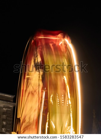 Abstract image of a rotating ferris wheel at night due to motion blur