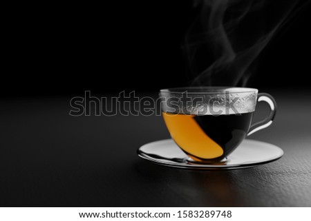 A cup of nice hot tea in a dark room