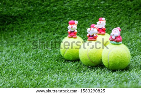 Tennis Christmas Holiday with Santa Claus and tennis ball on green grass